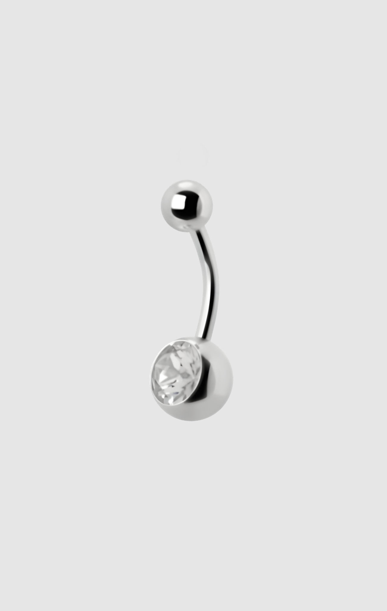 Lunar Orbit navel barbell in titanium with a radiant white zirconia stone, suitable for initial or upgraded navel piercings.