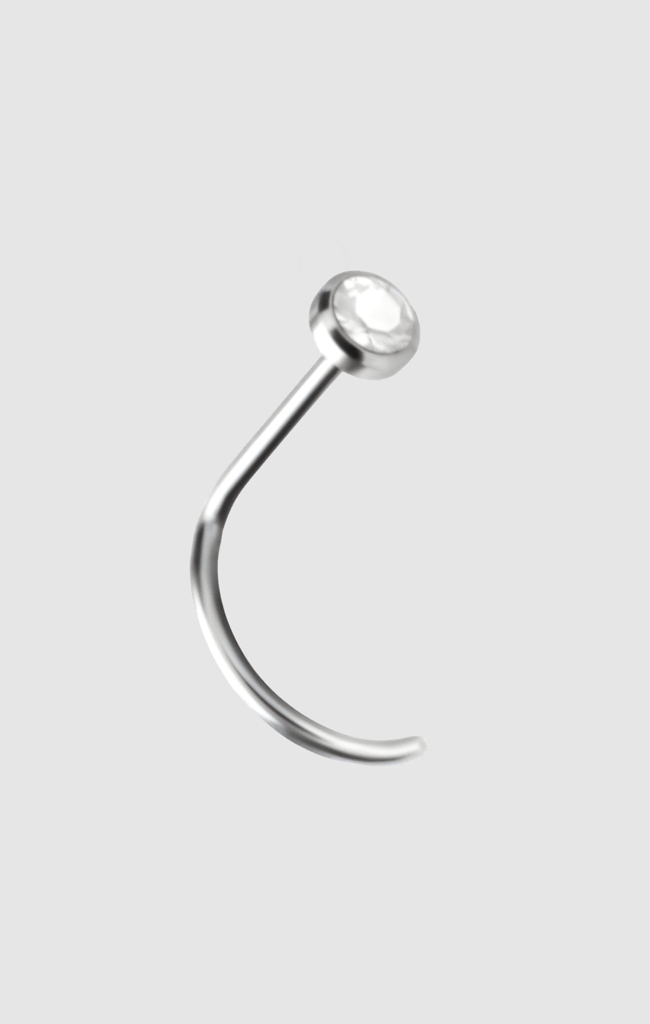 Spotlight titanium nostril stud with a radiant white zirconia stone, suitable for initial nostril piercings.