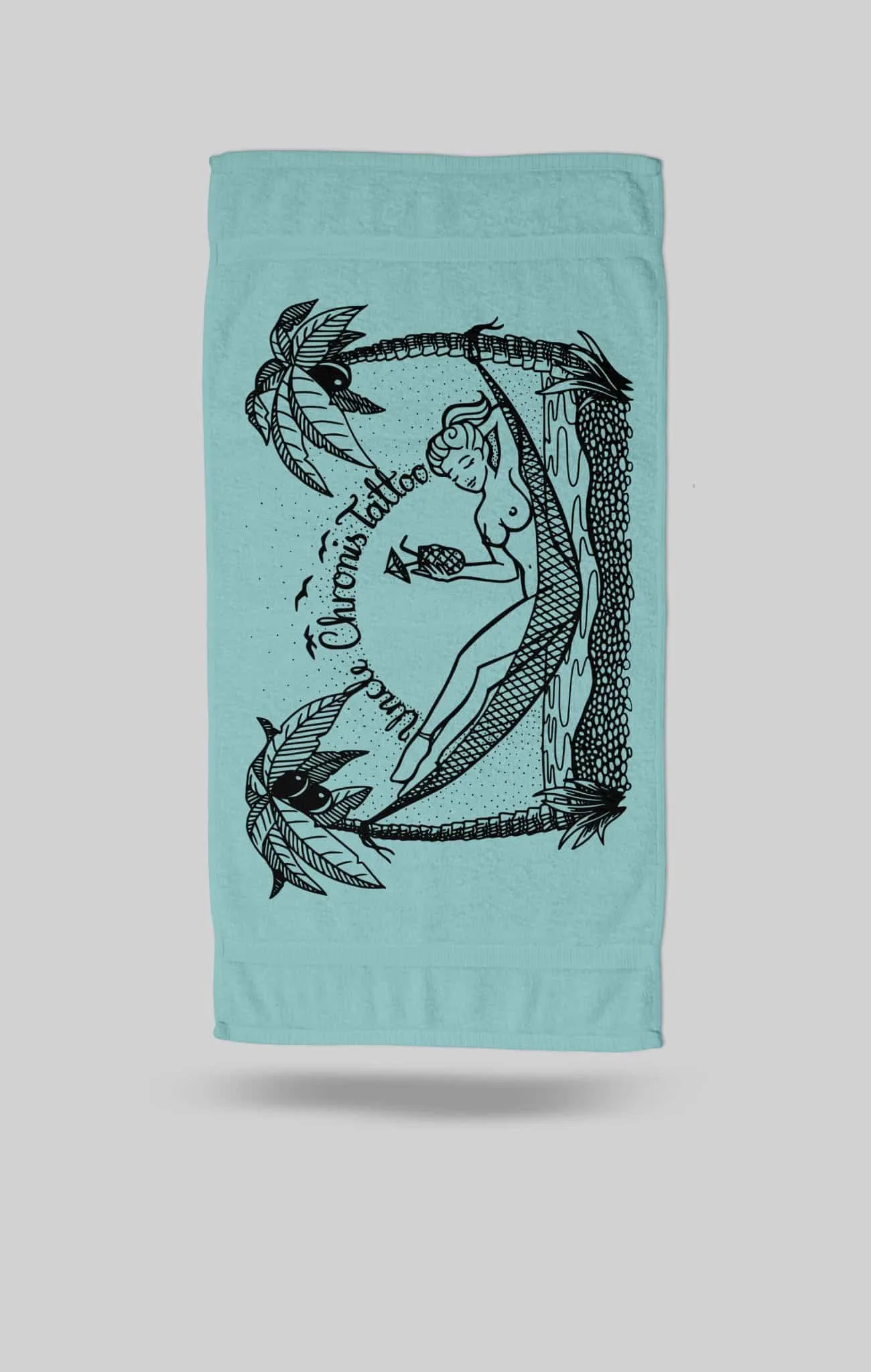 Chillin Tropical beach towel by Uncle Chronis Tattoo &ndash; 100% cotton, 76x150cm, cyan fabric with black tattoo-inspired tropical design